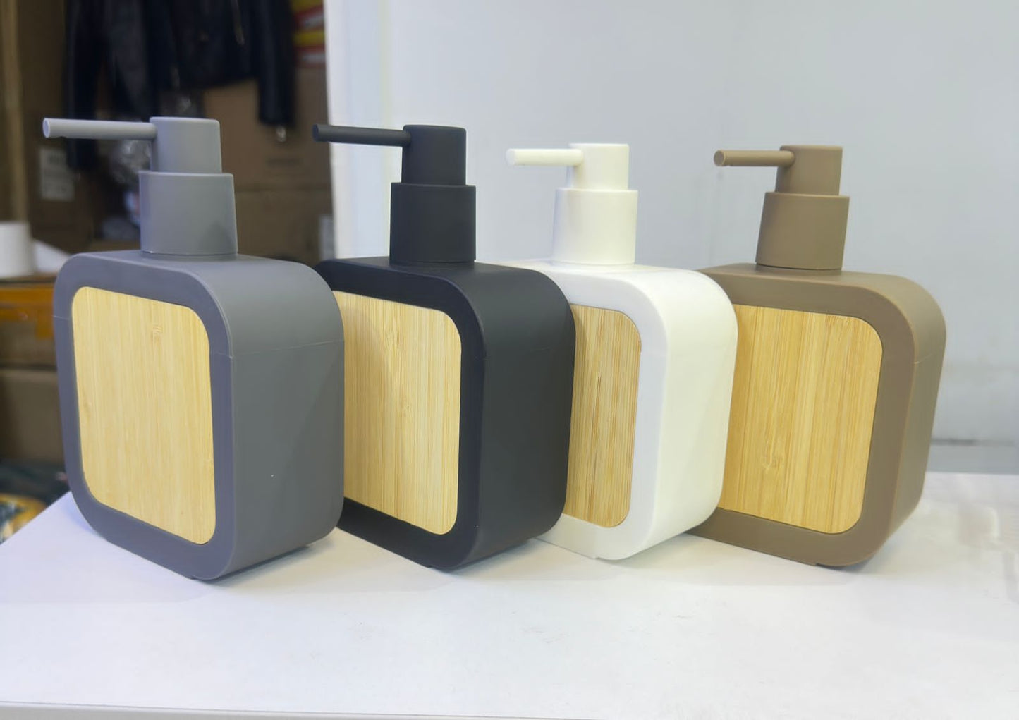 Square plastic soap dispenser with bamboo accent pump