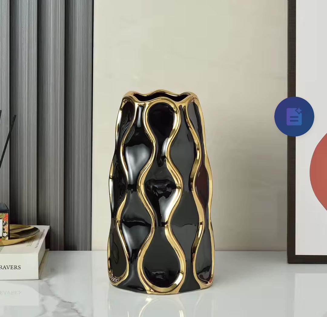 Black and white ceramic vase with golden trim.Very ideal for setting up center pieces