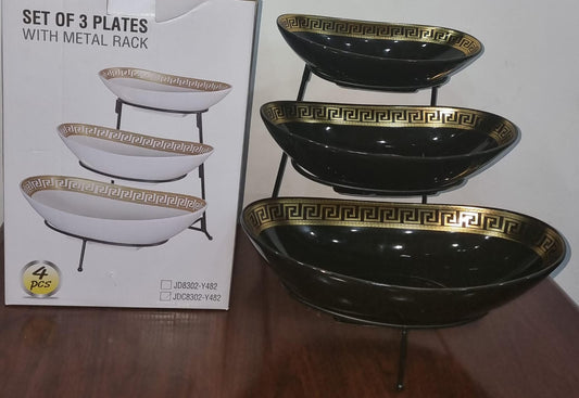 set of 3 ceramic fruit plates on black metal rack