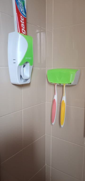Toothpaste dispenser with toothbrush holder